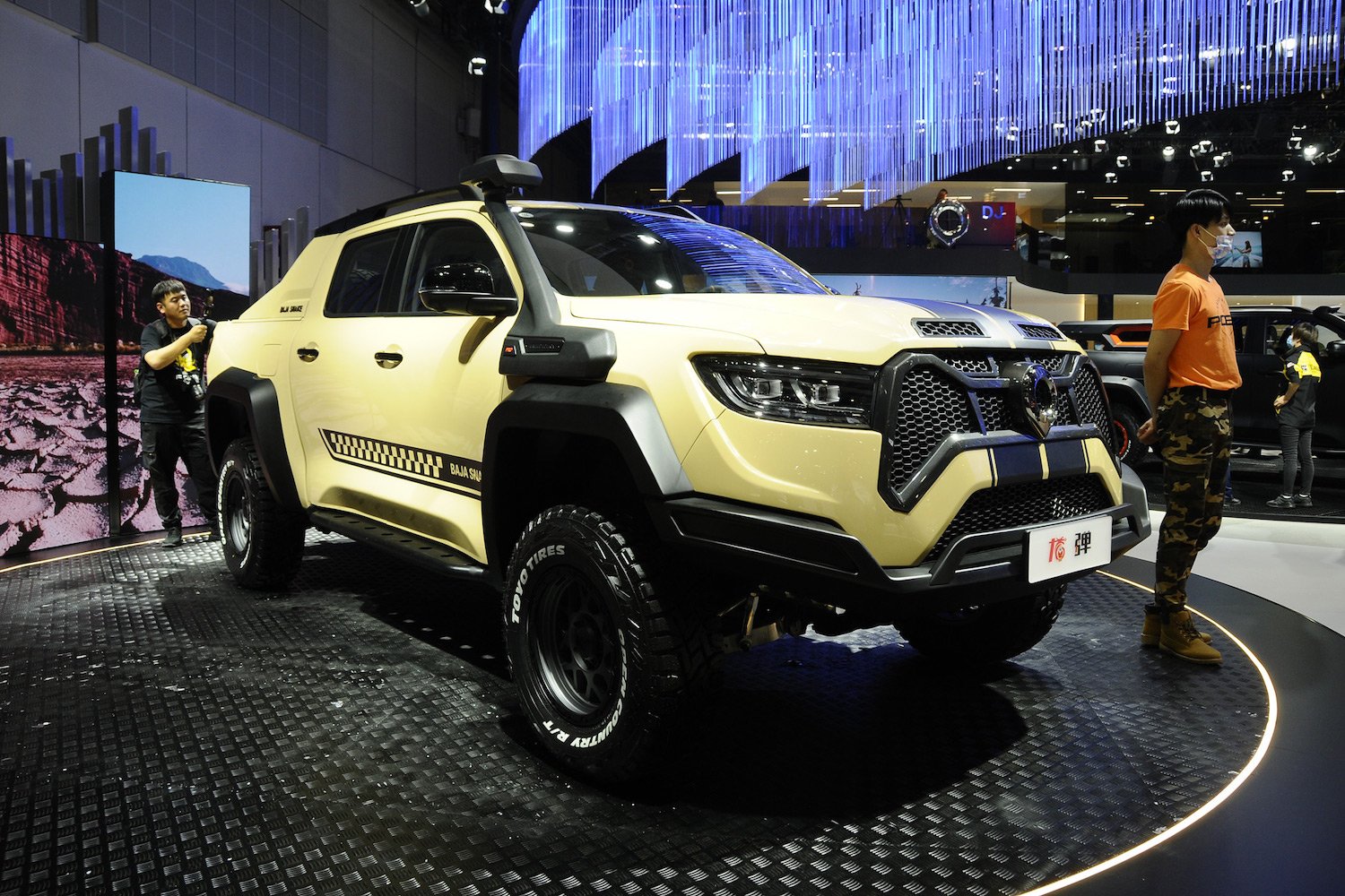Yellow SUV with black details at auto show.