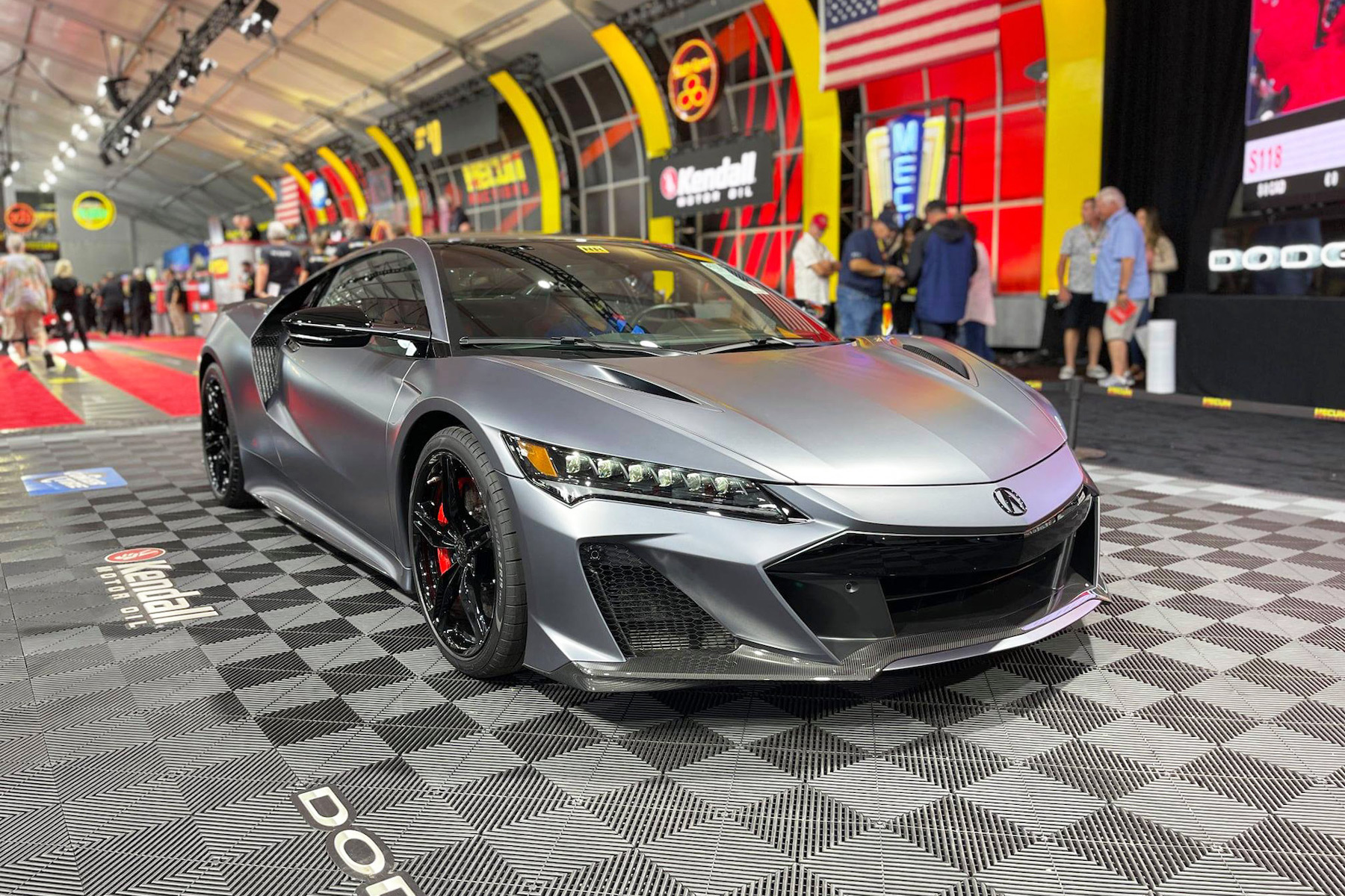 Japanese sports car displayed on checkered floor.