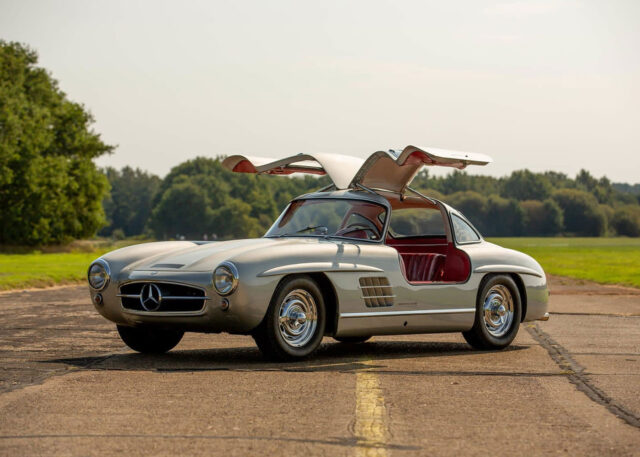A vintage Mercedes-Benz with gullwing doors open.