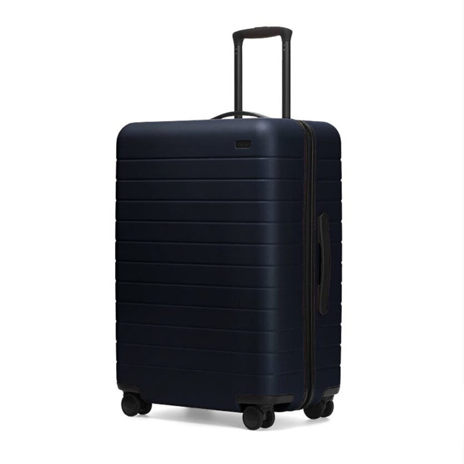 Stylish dark blue hard-shell suitcase with wheels.