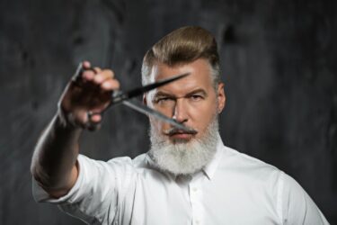 Styled barber emphasizes precision cuts.