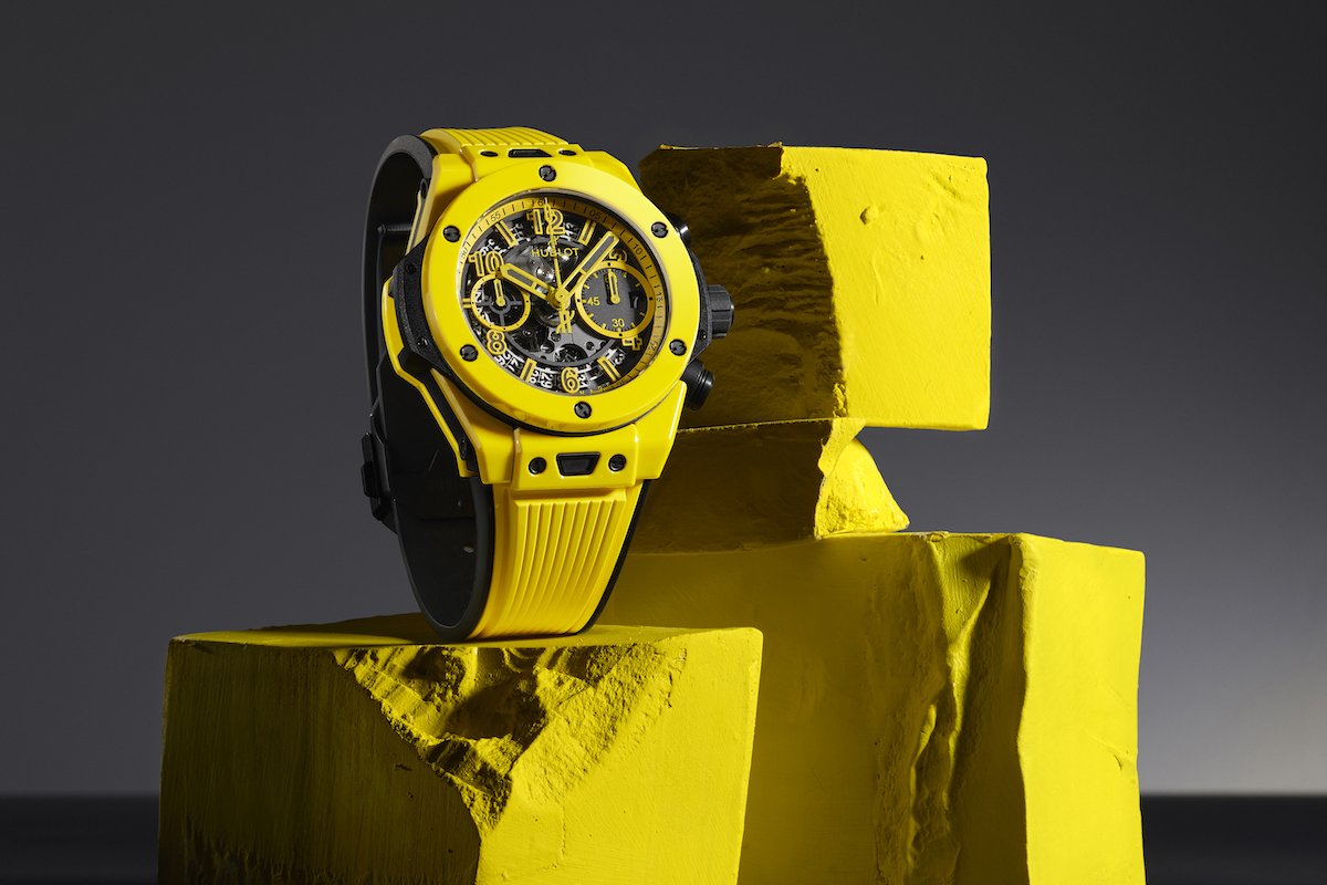Hublot yellow watch on abstract yellow display.
