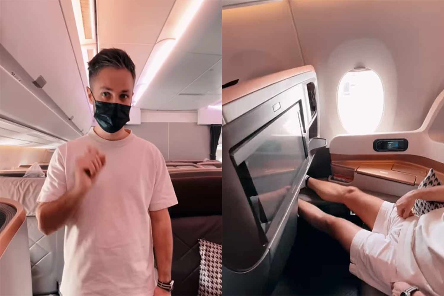 Masked person stands aisle; passenger reclines in bulkhead.