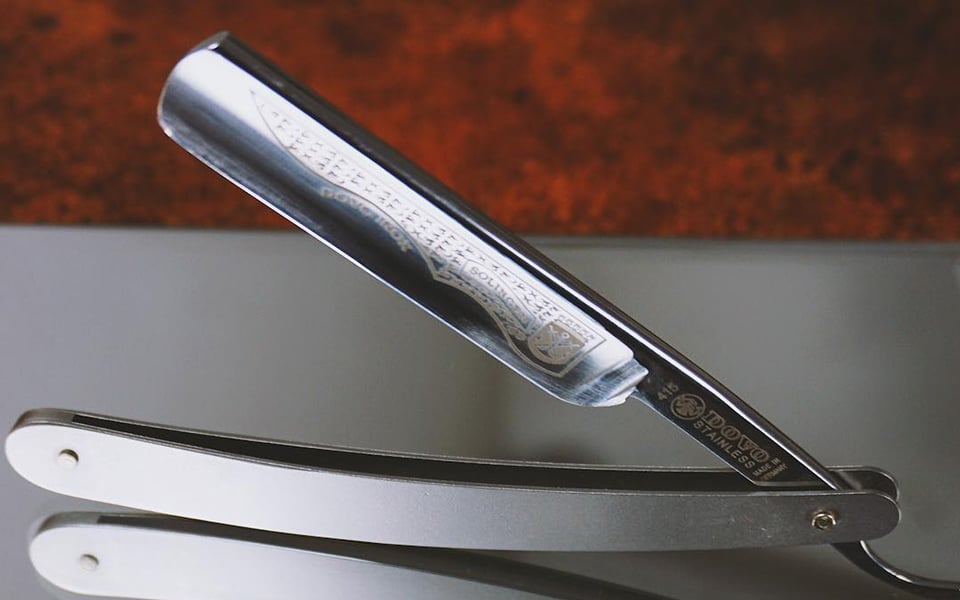 Engraved razor shines on surface.