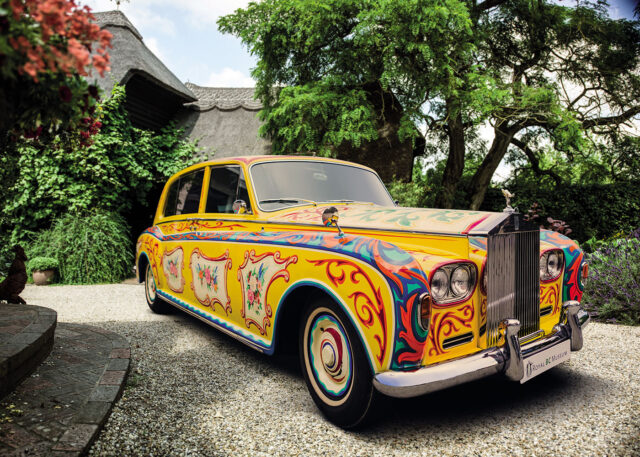 Vintage car with psychedelic John Lennon paint.