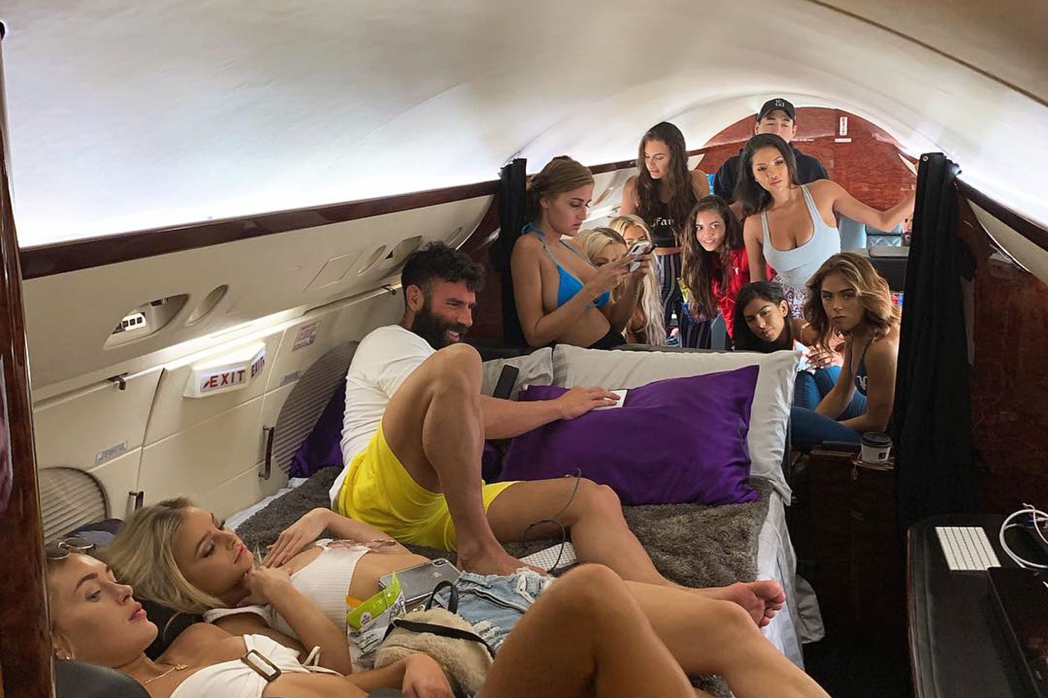 People relax in a private jet cabin.