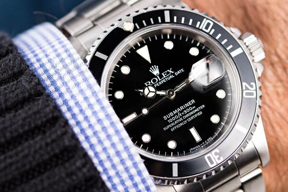 Close-up Rolex Submariner on wrist with sweater.