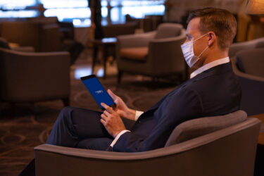 Traveler in lounge awaiting Singapore Airlines flight.