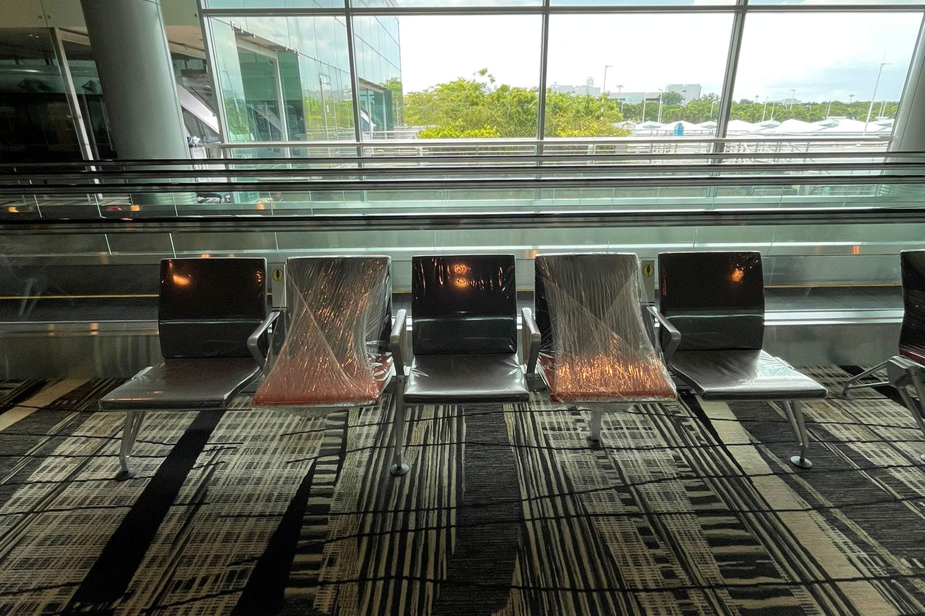 Partially wrapped seats at Singapore Airport reveal windows.