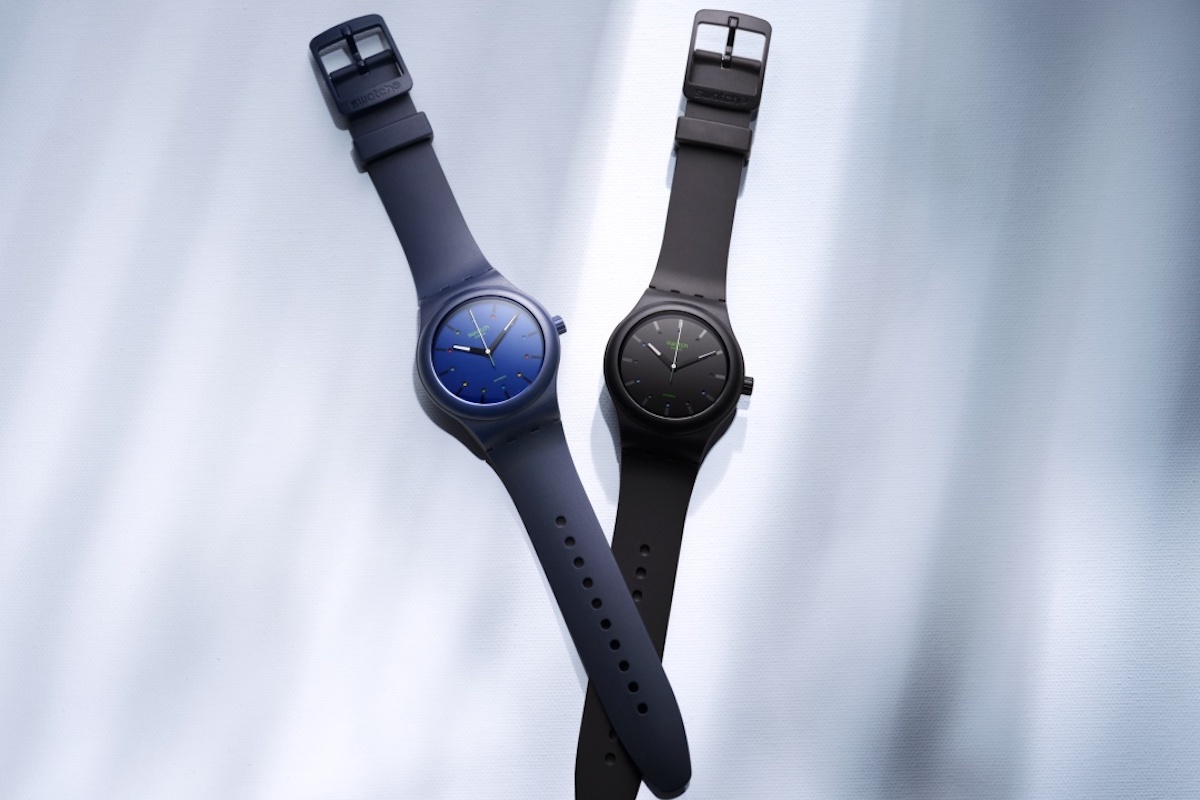 Two Swatch watches: blue and black designs.