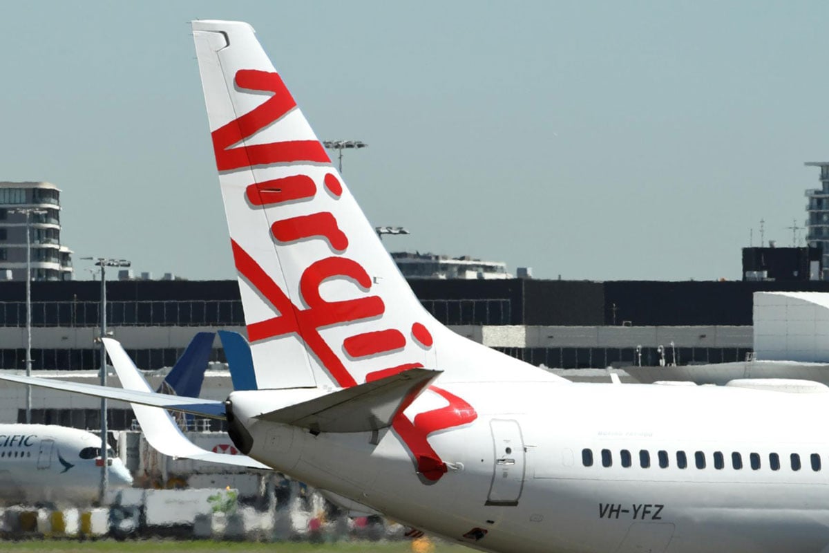 Virgin airplane on runway, evokes global travel.
