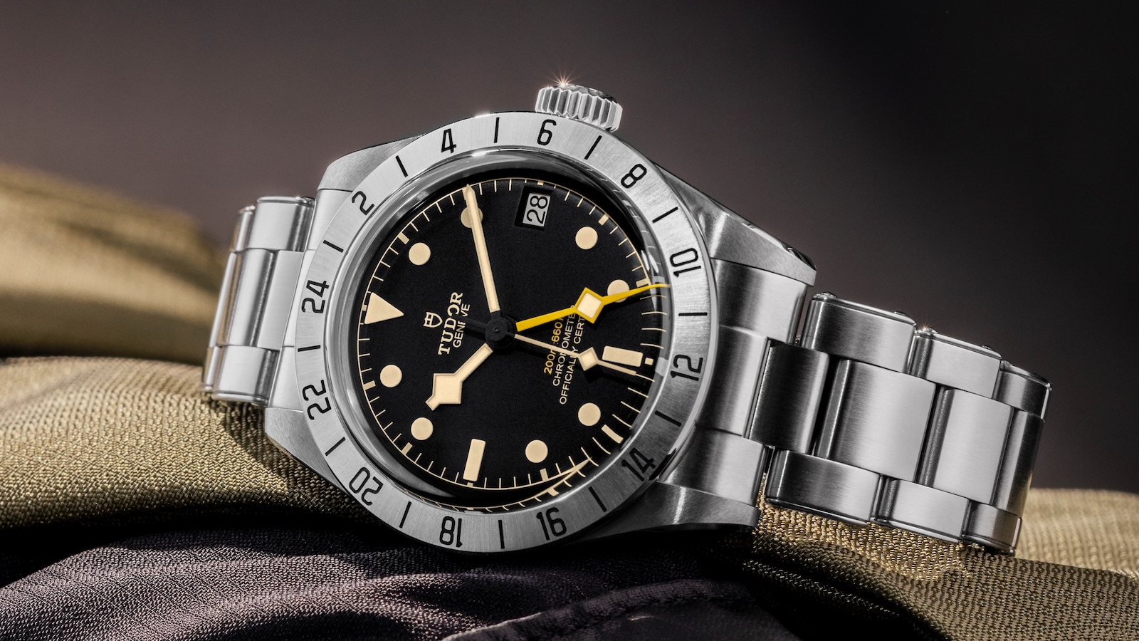 Grand Seiko stainless steel watch: black dial, yellow accents.
