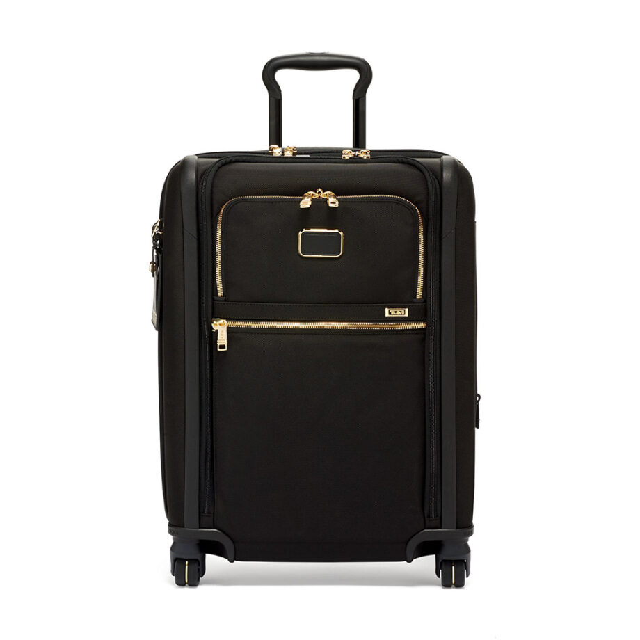 A black suitcase with gold zippers, four wheels.