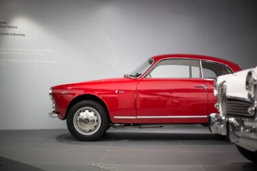 Red Alfa Romeo gleams vintage.