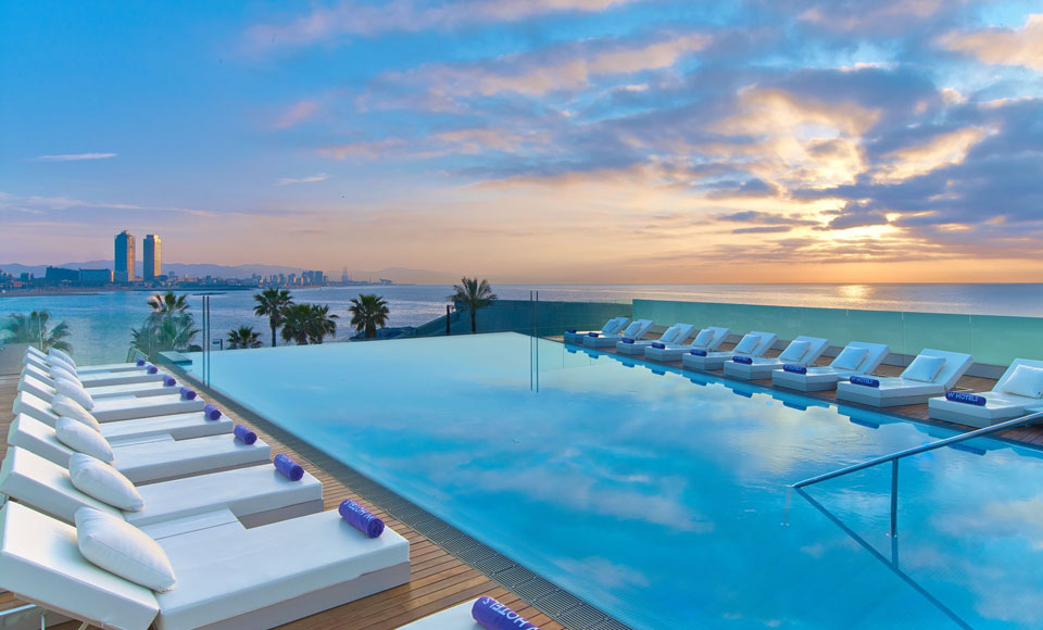 Infinity pool, Barcelona hotel sunset.